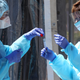 Health care workers at a drive-thru covid-19 testing station in San Francisco, California last March.